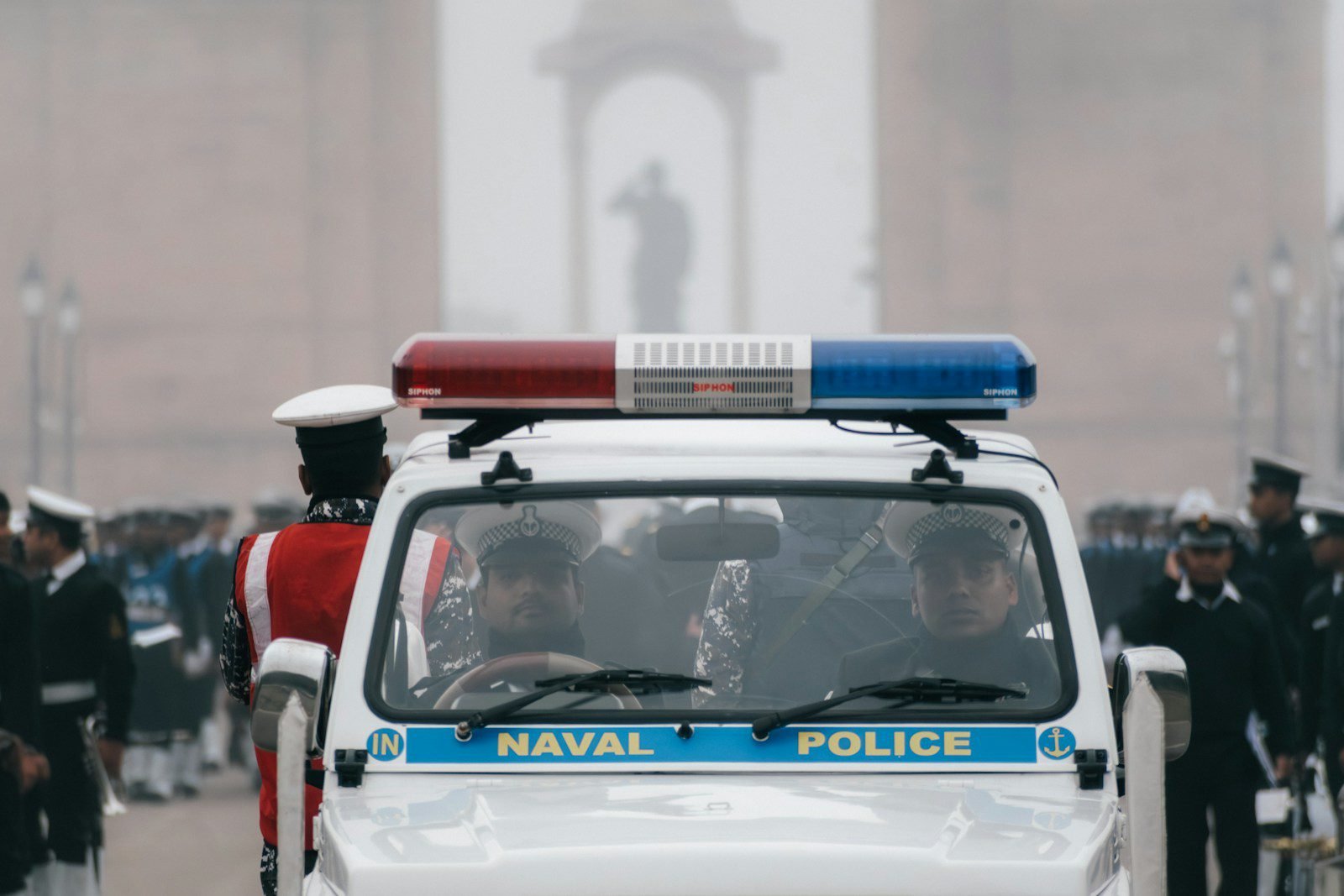 A naval police car driving down a street