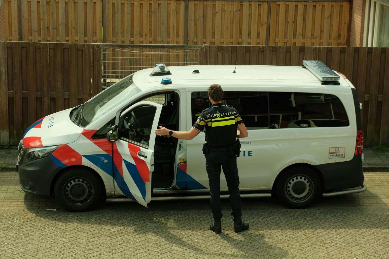 a police officer standing next to a van
