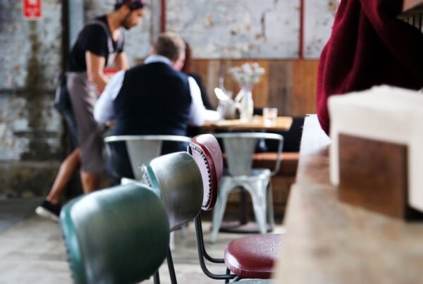 a couple of people sitting at a table in a room