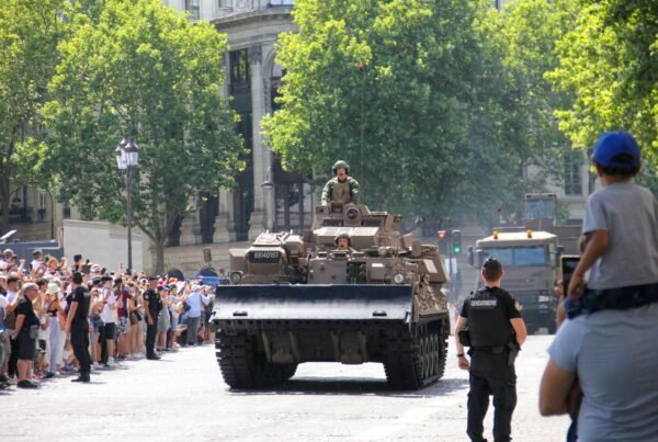 a large group of people watching a military vehicle
