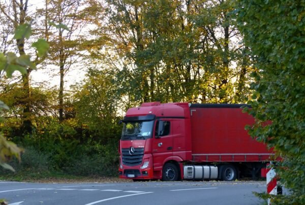 a red truck is parked on the side of the road