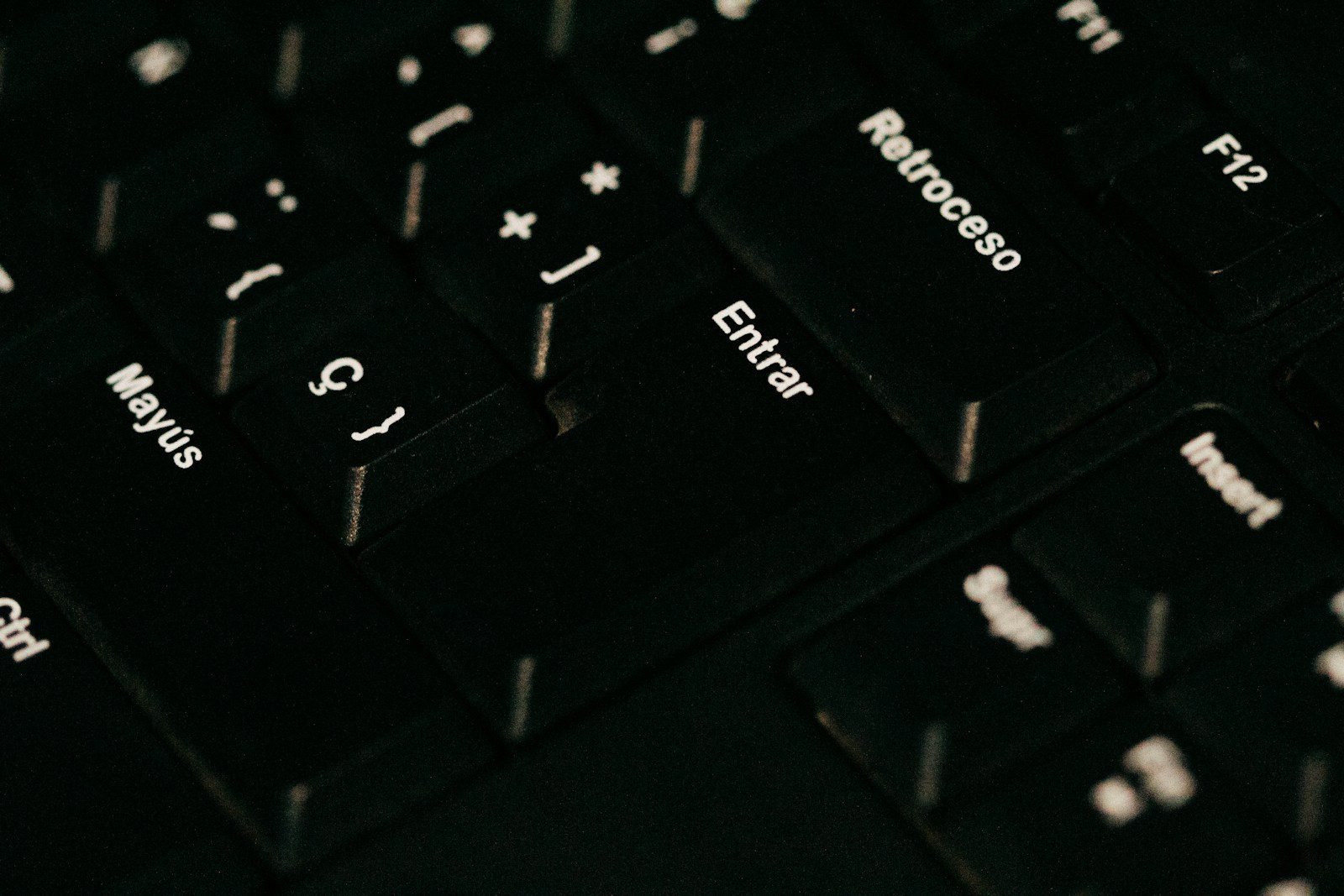 a close up of a black keyboard with white letters
